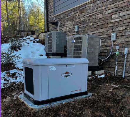 Generator installation near outdoor AC units in a snowy landscape, enhancing home energy reliability.