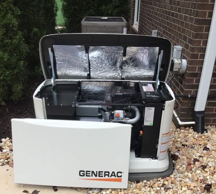 Generac home standby generator with open lid, showcasing internal components and wiring.